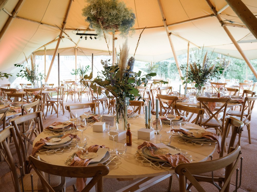 Beautiful table settings in a wedding tipi