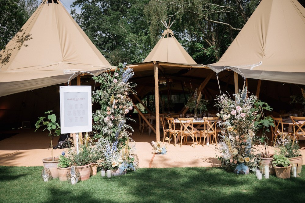 wedding tipis open sides showing tables, chairs and decorations