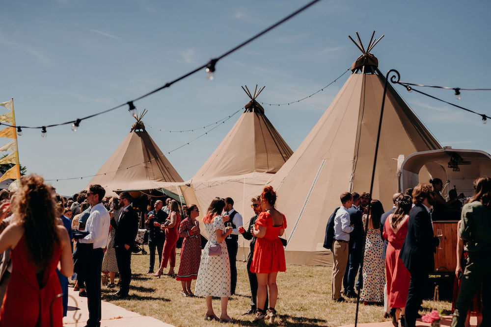 Wedding guests outside tipis