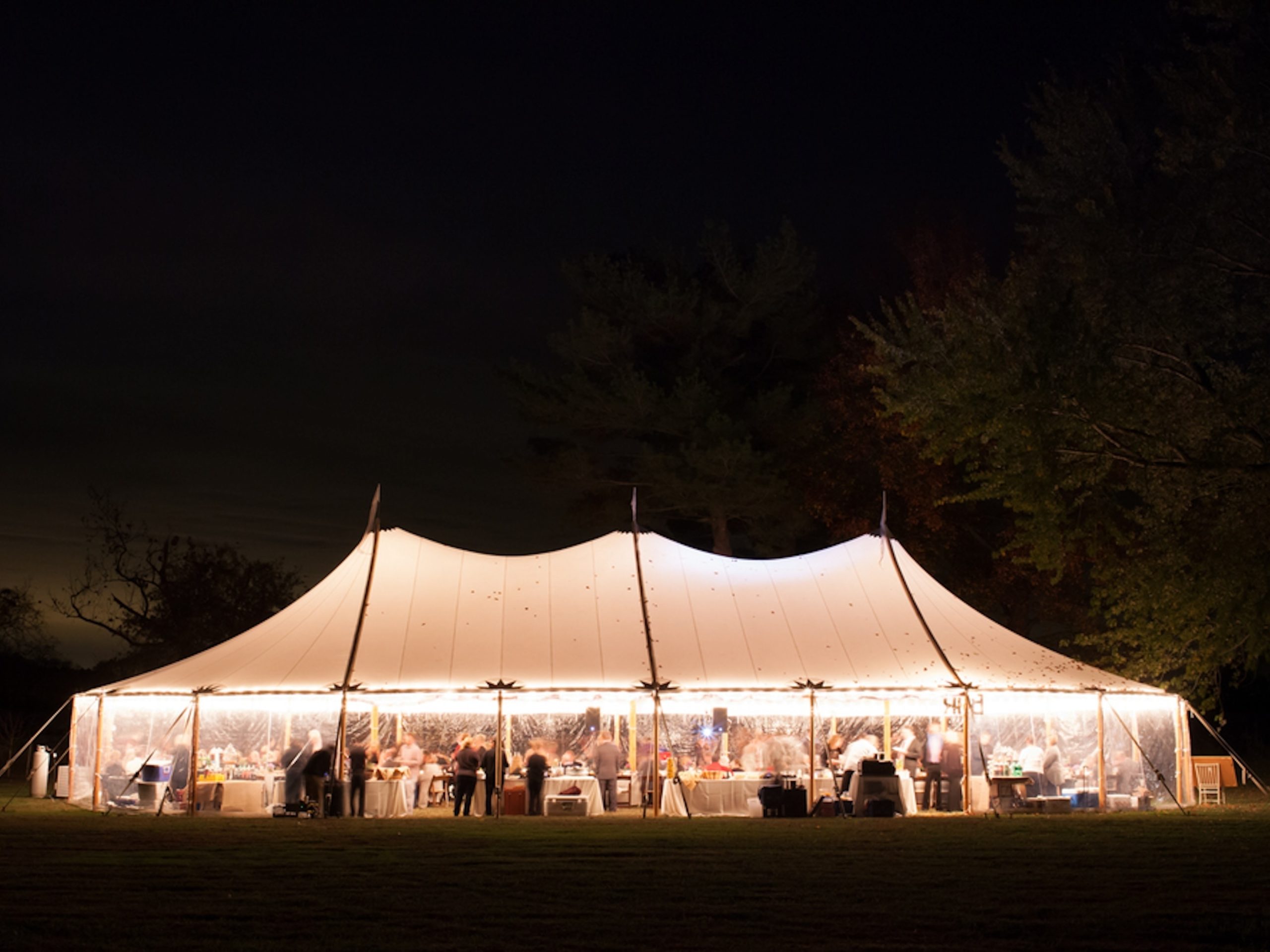 Sailcloth tent with lighting at night - Buffalo Tipi and Marquee hire - West Country and Cotswolds